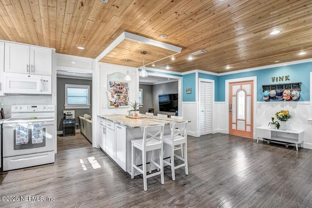 kitchen with white appliances, dark wood-type flooring, white cabinets, wainscoting, and wooden ceiling