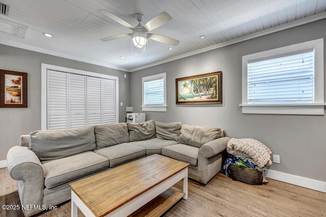 living room featuring crown molding, baseboards, recessed lighting, light wood-style floors, and a ceiling fan