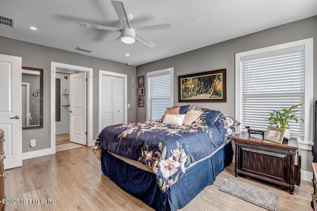 bedroom with visible vents, baseboards, light wood-style floors, and ceiling fan