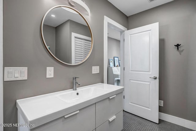 bathroom featuring vanity, baseboards, and tile patterned flooring