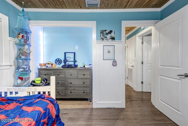 bedroom with visible vents, wood finished floors, ornamental molding, and wooden ceiling