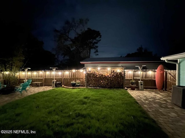 yard at twilight with a patio and fence