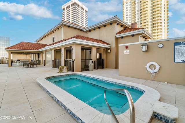 view of pool with outdoor dining area, a swimming pool, fence, and a patio area