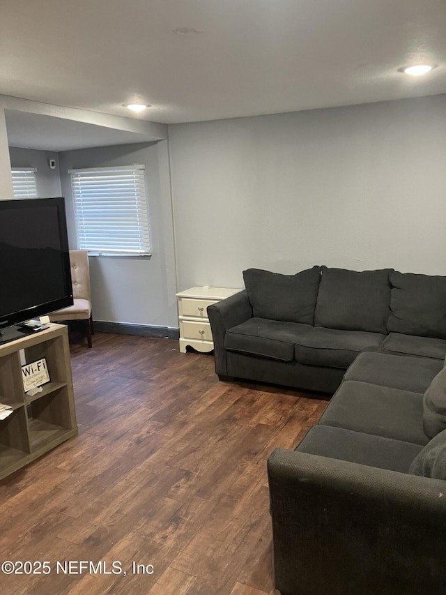 living room with dark wood-style floors and baseboards