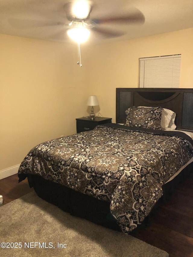 bedroom with wood finished floors, baseboards, and ceiling fan