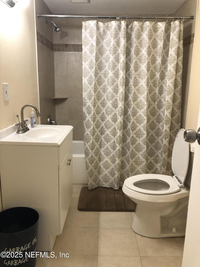 full bath featuring tile patterned floors, vanity, toilet, and shower / bath combo with shower curtain