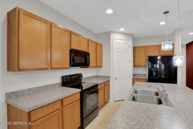 kitchen with pendant lighting, light countertops, recessed lighting, black appliances, and a sink