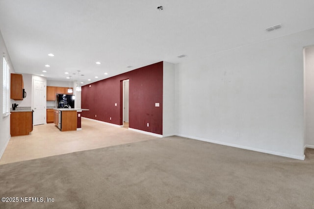 unfurnished living room featuring recessed lighting, baseboards, light carpet, and visible vents