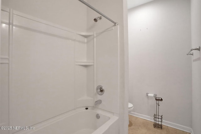 full bathroom featuring toilet, washtub / shower combination, and baseboards