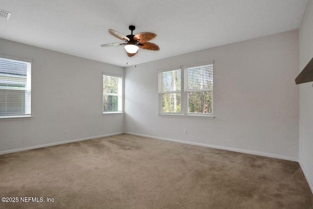 unfurnished room featuring visible vents, baseboards, carpet, and ceiling fan