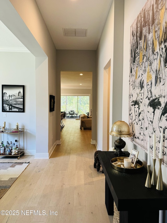 hallway featuring recessed lighting, baseboards, visible vents, and light wood finished floors