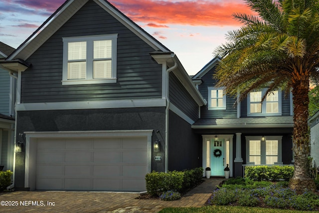 traditional home with driveway and an attached garage