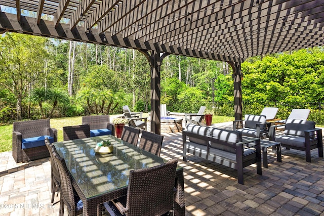 view of patio / terrace featuring a fenced backyard, an outdoor living space with a fire pit, a pergola, and outdoor dining space