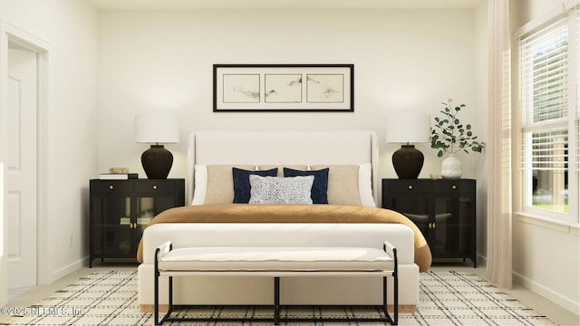 bedroom featuring multiple windows, light colored carpet, and baseboards