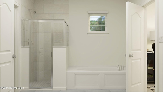 bathroom featuring a shower stall and a garden tub