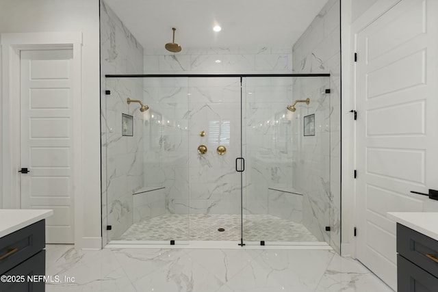 full bath featuring vanity, recessed lighting, marble finish floor, and a marble finish shower