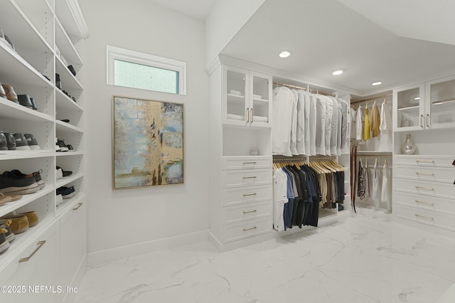 walk in closet with marble finish floor