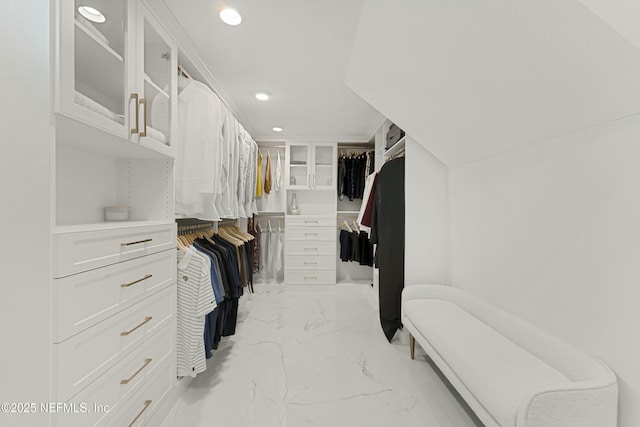 walk in closet with marble finish floor