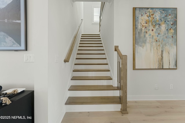 stairway with wood finished floors