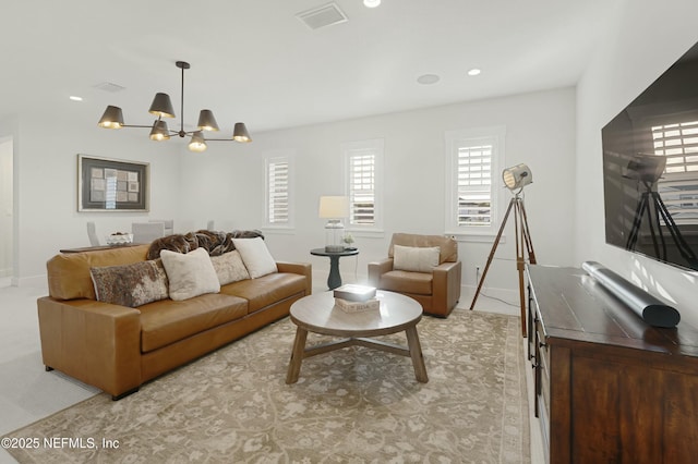 living area featuring recessed lighting, baseboards, visible vents, and a chandelier