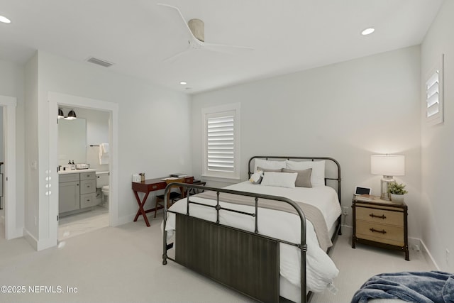 bedroom featuring visible vents, light carpet, ensuite bath, recessed lighting, and baseboards