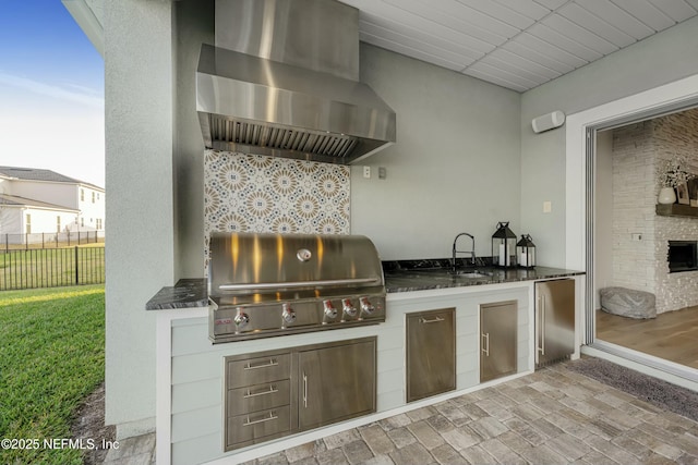 view of patio / terrace with a sink, area for grilling, a grill, and fence