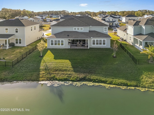 drone / aerial view featuring a residential view and a water view