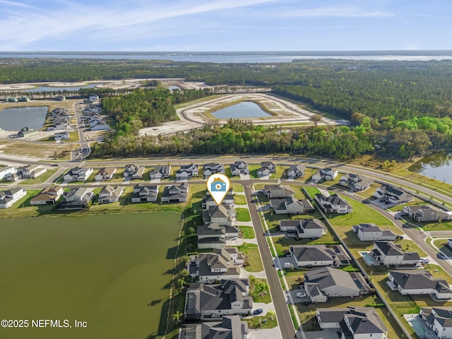 birds eye view of property with a water view and a residential view