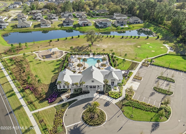 drone / aerial view with a residential view and a water view