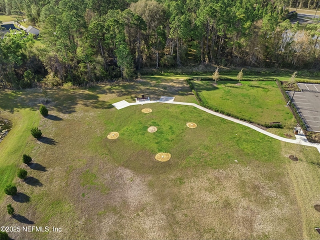 birds eye view of property with a view of trees