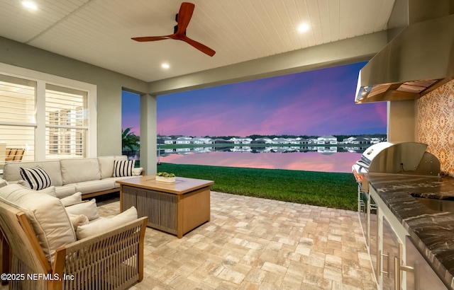 patio terrace at dusk featuring an outdoor hangout area and ceiling fan