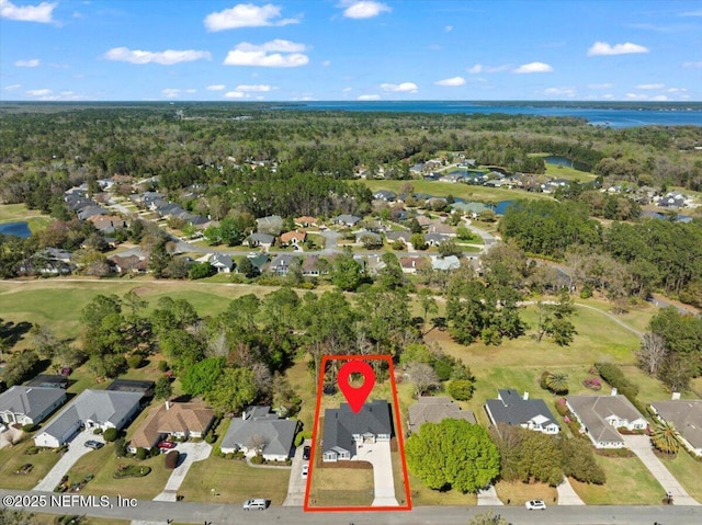 aerial view with a forest view, a residential view, and a water view