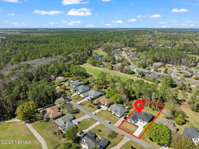 birds eye view of property featuring a residential view and a wooded view