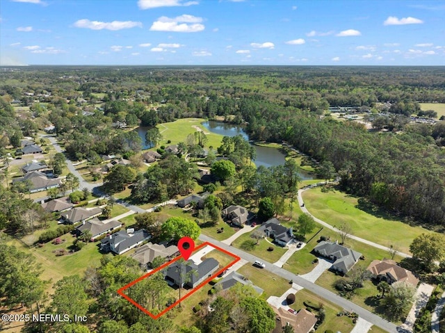 aerial view with a wooded view, a water view, and a residential view