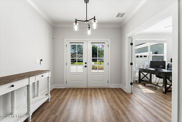 doorway with visible vents, plenty of natural light, french doors, and crown molding