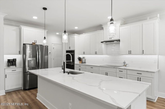 kitchen featuring an island with sink, wood finished floors, white cabinets, black appliances, and a sink