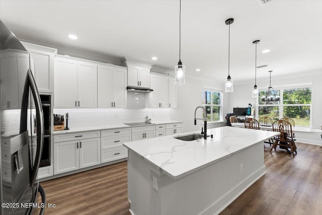 kitchen with backsplash, black electric stovetop, ornamental molding, stainless steel refrigerator with ice dispenser, and a sink