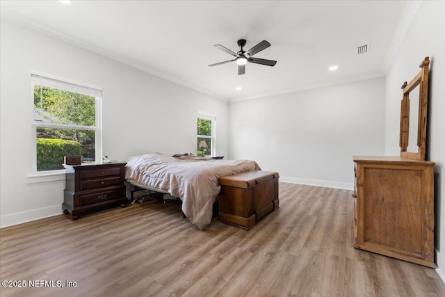 bedroom with visible vents, ornamental molding, recessed lighting, light wood finished floors, and baseboards