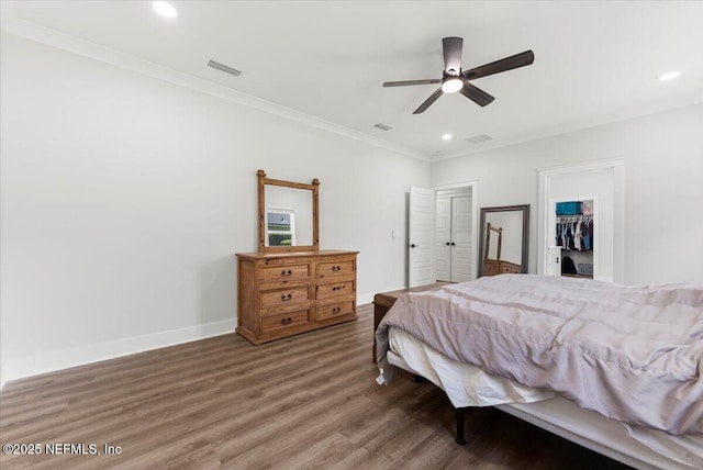 bedroom with recessed lighting, wood finished floors, visible vents, and baseboards