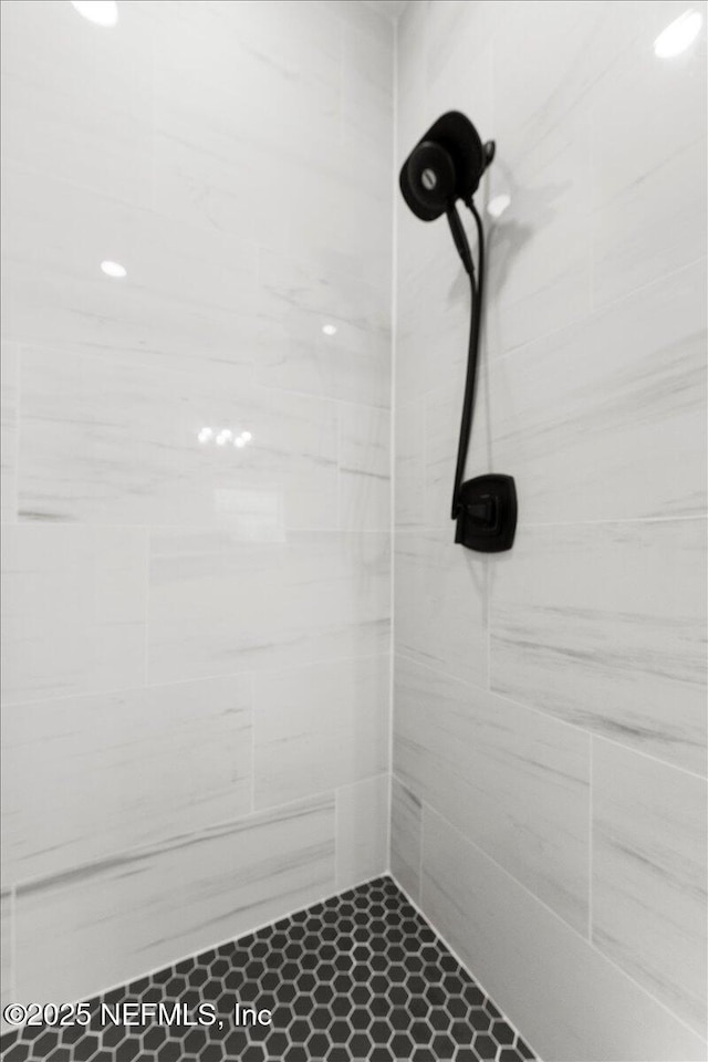 full bath with a tile shower