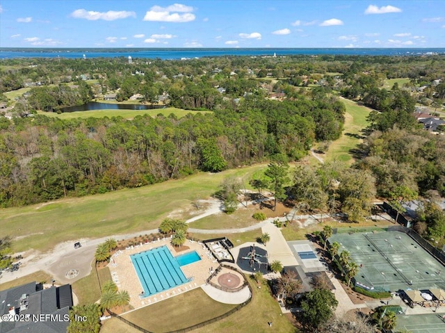 aerial view with a wooded view and a water view