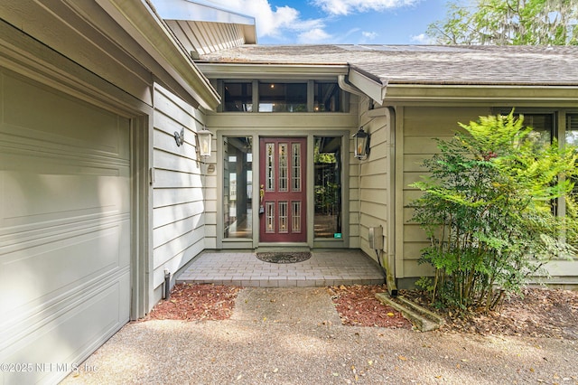 property entrance featuring french doors and a shingled roof