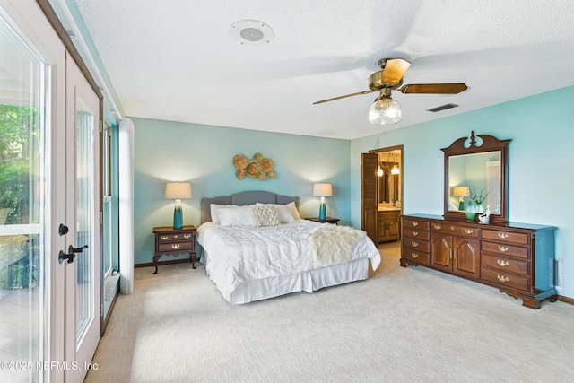 bedroom featuring light colored carpet, baseboards, ensuite bathroom, and visible vents