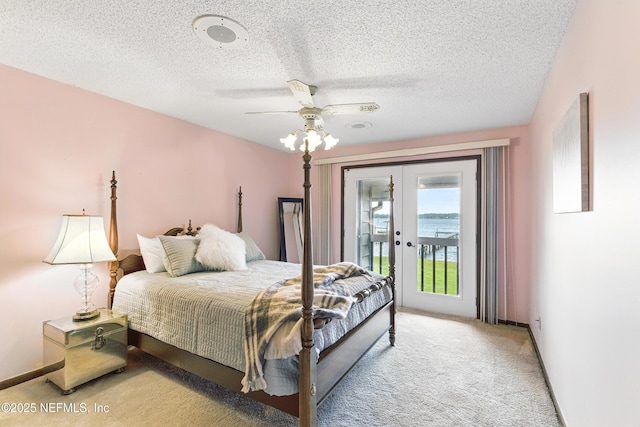 bedroom with access to outside, french doors, light carpet, and a textured ceiling