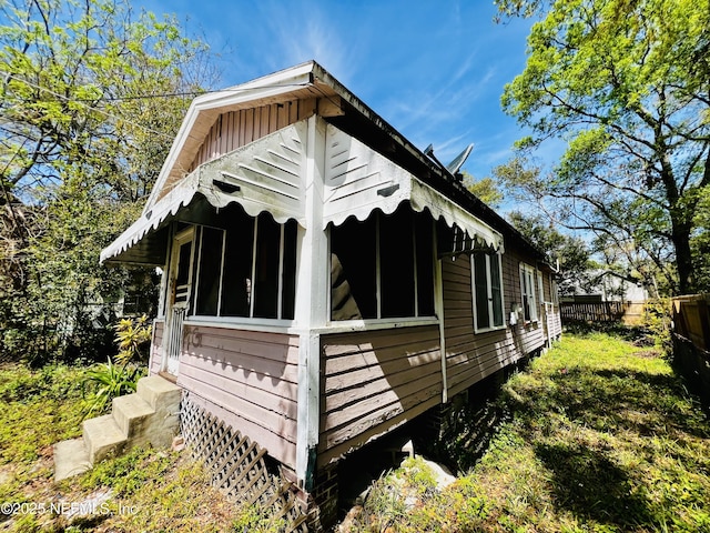 view of home's exterior featuring fence