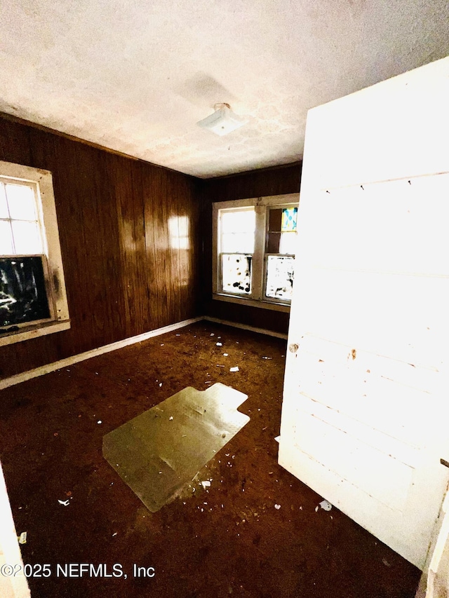 unfurnished room with a textured ceiling