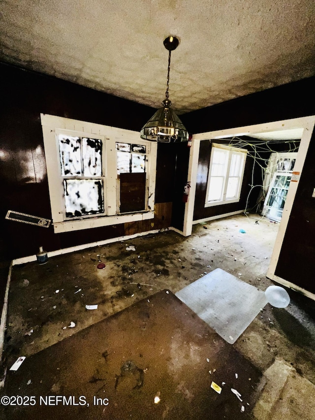 unfurnished dining area with a notable chandelier