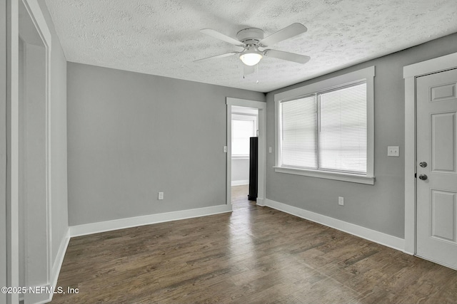 interior space featuring wood finished floors, baseboards, and ceiling fan