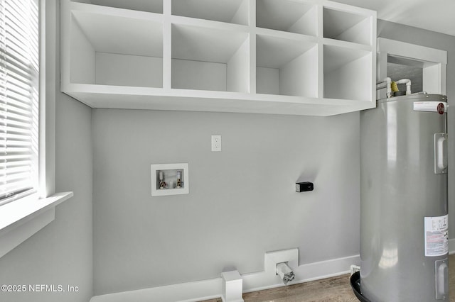 laundry area featuring electric water heater, baseboards, laundry area, hookup for a washing machine, and wood finished floors