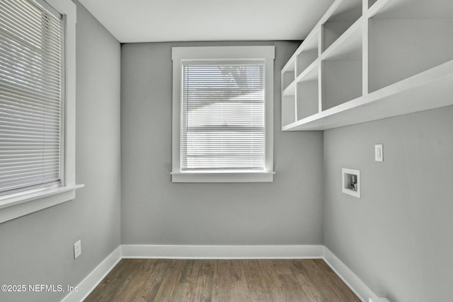 laundry area featuring hookup for a washing machine, baseboards, dark wood-style flooring, and laundry area